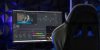 Curved monitor displaying video editing software in a tech-savvy workspace with mood lighting.
